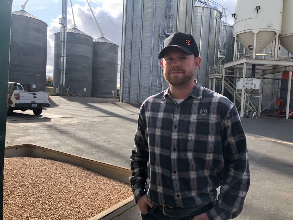 Kyle Hinrichs helps run the family business outside of Pullman, Wash. Right now the company is drying beans as fast as possible with several machines, but it’s an around the clock job. CREDIT: Anna King/N3
