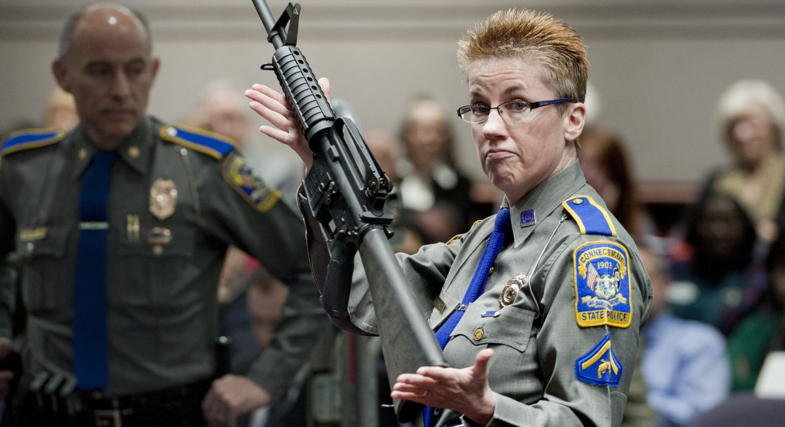 Connecticut State Police Detective Barbara J. Mattson holds a Bushmaster AR-15-style rifle