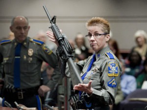 Connecticut State Police Detective Barbara J. Mattson holds a Bushmaster AR-15-style rifle