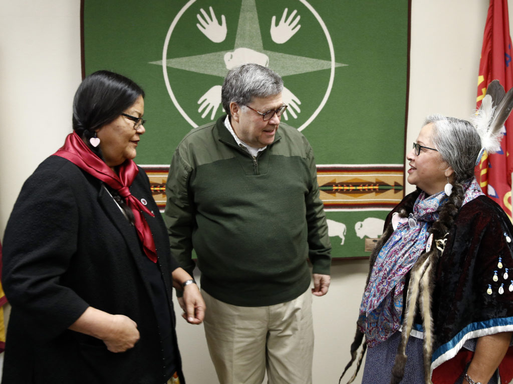 Attorney General William Barr speaks with Myrna DuMontier (left) and Charmel Gillin (right), councilwomen with the Confederated Salish and Kootenai Tribes on Friday on the Flathead Reservation in Pablo, Mont. CREDIT: Patrick Semansky/AP