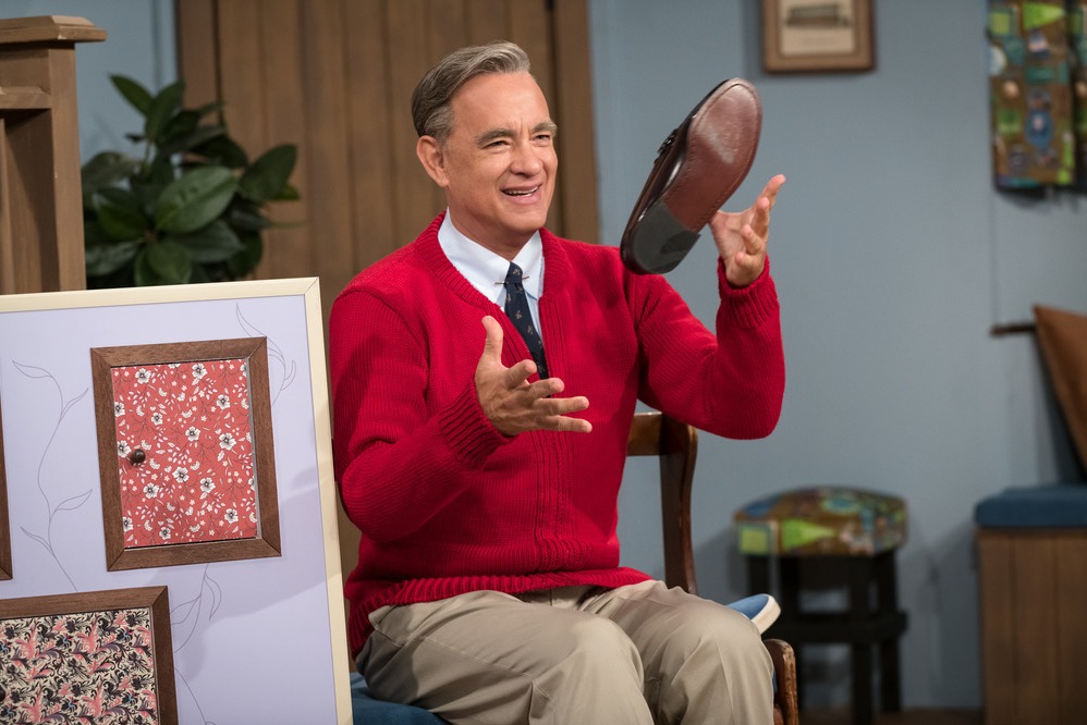 Tom Hanks stars as Fred Rogers in A Beautiful Day in the Neighborhood. Hanks watched a lot of Mister Rogers to research the role and found as an adult, you don't really "get it": "Why is it taking so long? What's the big deal? What are these fish?" CREDIT: Lacey Terrell/CTMG