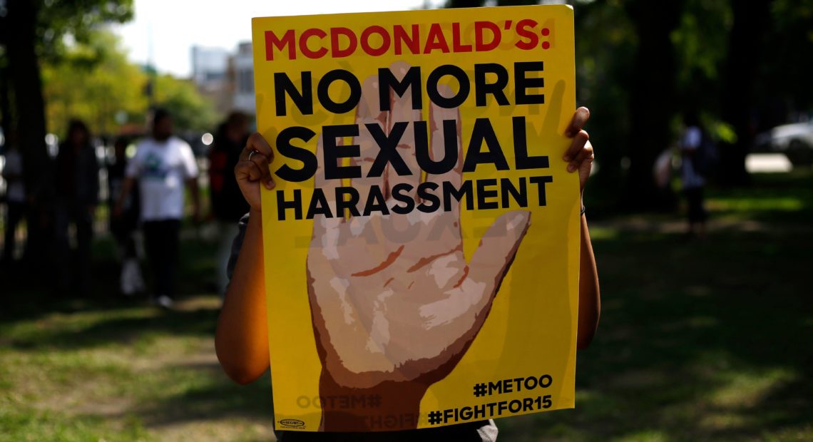 A McDonald's employee holds a sign during a 2018 protest