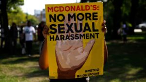 A McDonald's employee holds a sign during a 2018 protest
