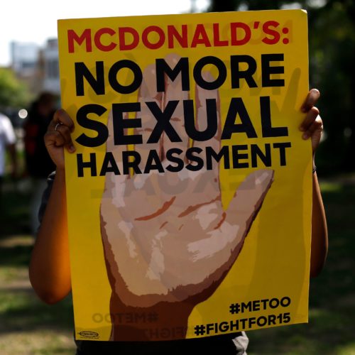 A McDonald's employee holds a sign during a 2018 protest