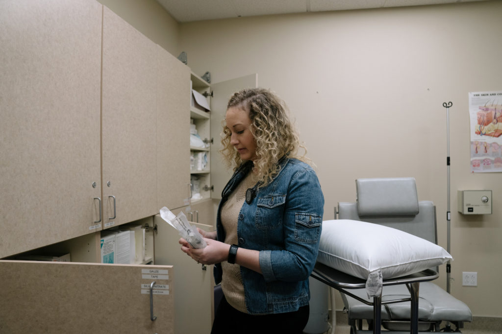 Katie Buckman, a third-year medical student at Pacific Northwest University of Health Sciences, gathers supplies for her volunteer work at the Yakima Union Gospel Mission's medical clinic. CREDIT: Jovelle Tamayo for NPR