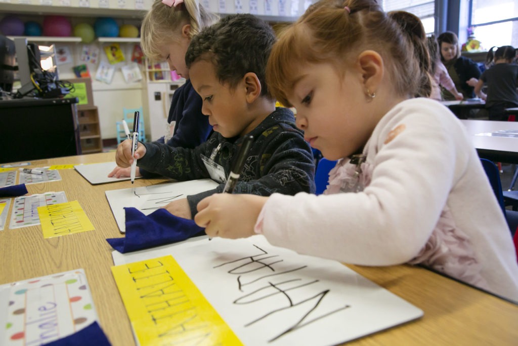 Pre-K students at Boise’s Garfield Elementary School work on writing their names. CREDIT: Sami Edge/Idaho Education News