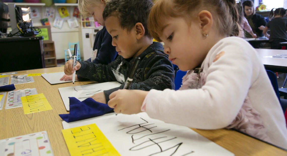 Pre-K students at Boise’s Garfield Elementary School work on writing their names. CREDIT: Sami Edge/Idaho Education News