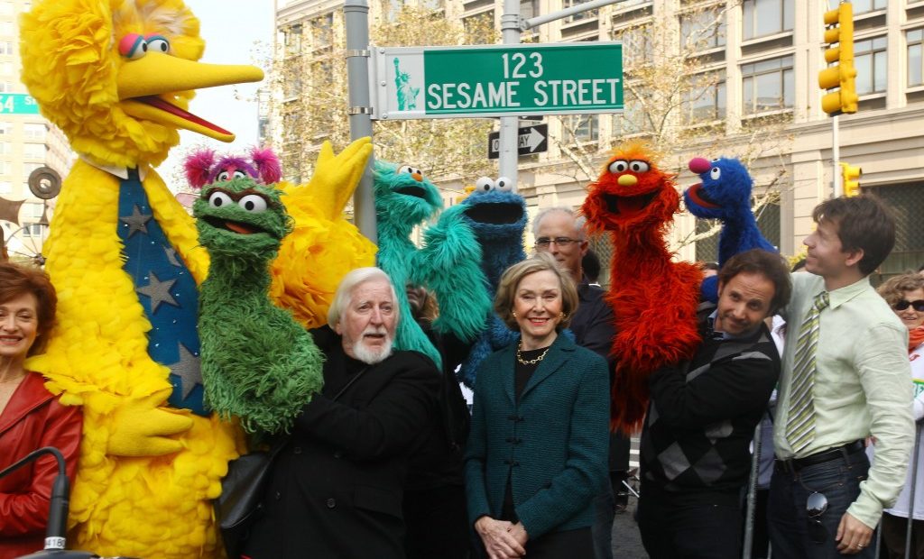 Puppeteer Caroll Spinney (L-R), Sesame Street co-founder and TV producer Joan Ganz Cooney, and Sesame Street cast members pose under a ‘123 Sesame Street’ sign at the ‘Sesame Street’ on Nov. 9, 2009 in New York City. Photo by Astrid Stawiarz/Getty Images