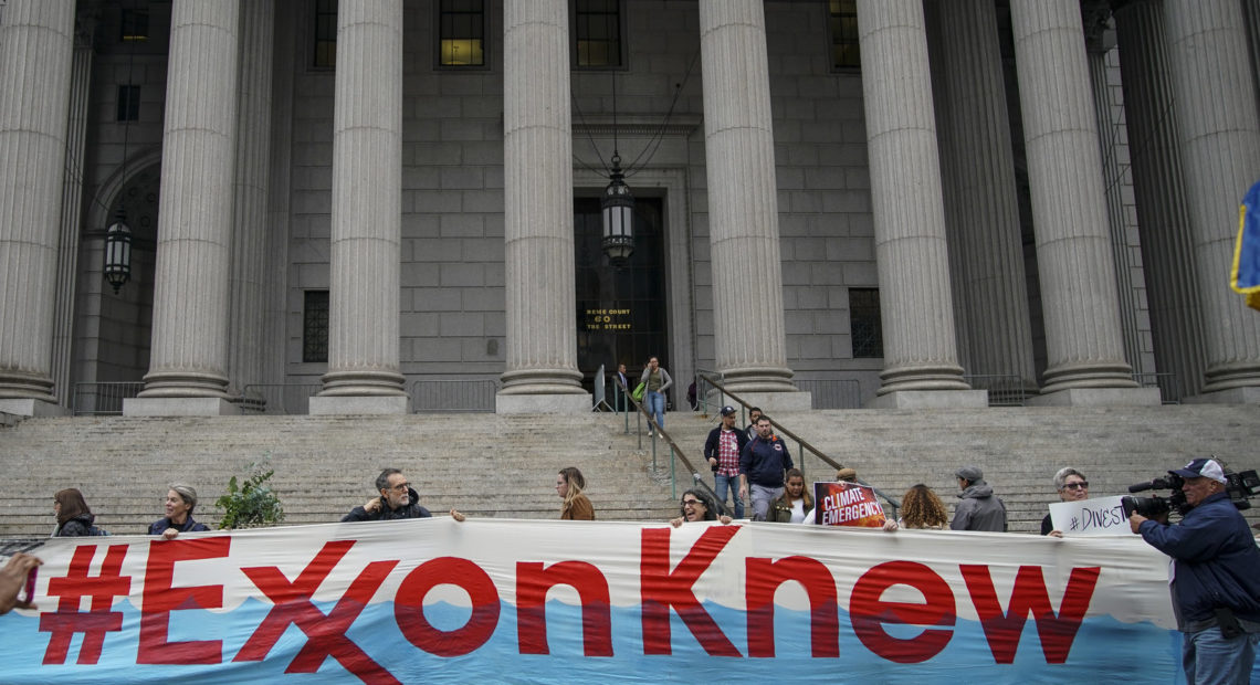 Environmental activists rally outside of New York Supreme Court in October in Manhattan, the first day of the trial accusing ExxonMobil of misleading shareholders about its climate change accounting. CREDIT: Drew Angerer/Getty Images