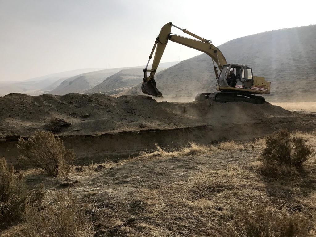 After the geologists are finished studying the fault scarp in the trench, they fill it back in. They plan to dig another trench in 2020 to study this geologic feature even more. CREDIT: Courtney Flatt/NWPB