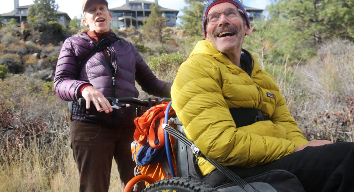 Geoff Babb (seated) hasn't walked since he suffered two brainstem strokes 14 years ago. That prompted him to focus on helping people with serious disabilities access trails, and an outdoor lifestyle. CREDIT: Emily Cureton/OPB