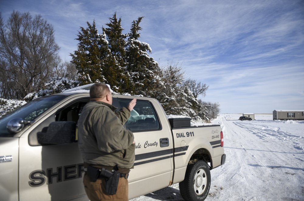 Lester Plank, a deputy with the Brule County Sheriff's Department, looks in the direction of a plane crash on Monday, Dec. 2, 2019 in Chamberlain, S.D. Nine people were killed and three people were injured in a plane crash on Saturday, Nov. 30. CREDIT: Abigail Dollins/The Argus Leader via AP