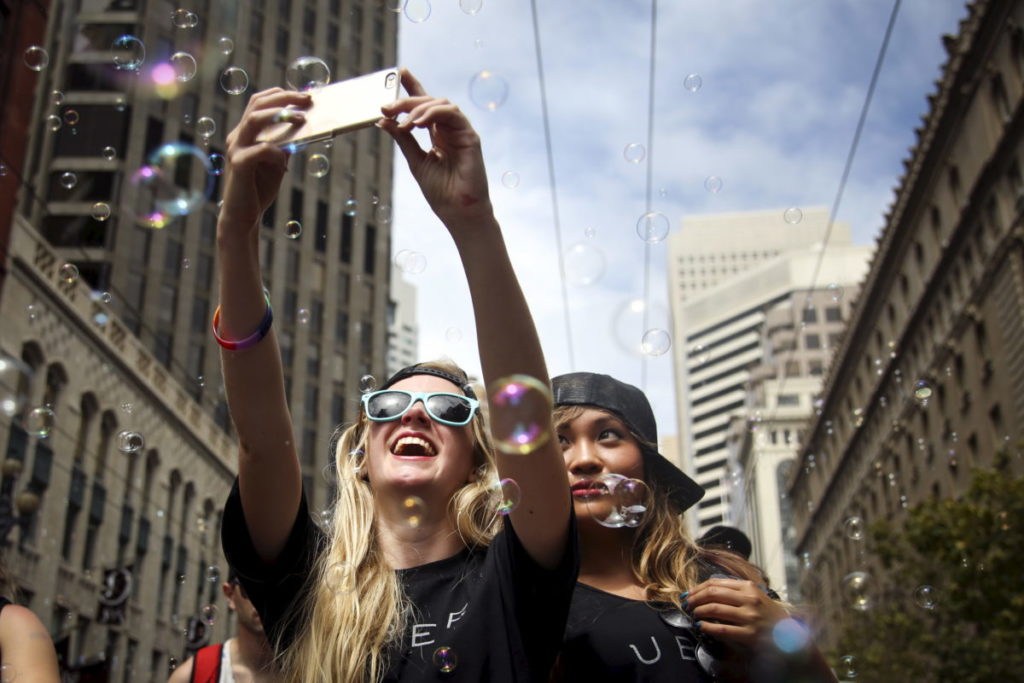 Two women take a selfie while marching in a Pride parade in San Francisco, California June 28, 2015. CREDIT: Nouvelage/Reuters