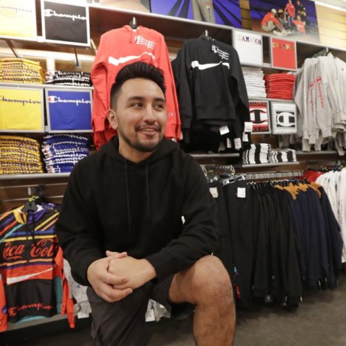 Victor Duran, a co-manager of a sports apparel store at the Southcenter mall, south of Seattle. Duran is one employee who could benefit from new overtime rules in Washington, which will allow hundreds of thousands of workers who have been exempt to begin collecting when they work more than 40 hours per week. CREDIT: Elaine Thompson/AP