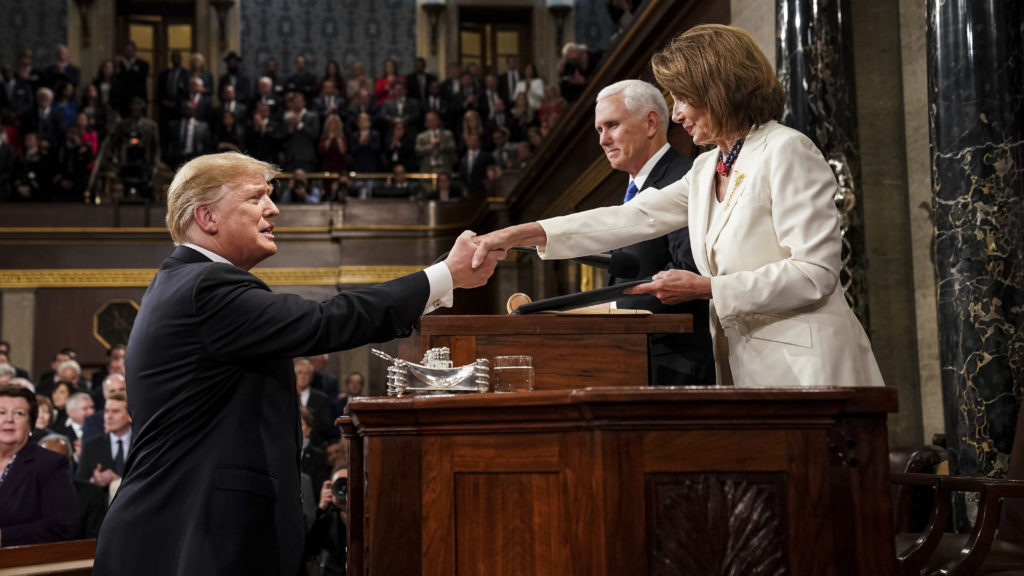 President Trump shakes hands with House Speaker Nancy Pelosi as Vice President Pence looks on in the House chamber before giving his State of the Union address to a joint session of Congress on Feb. 5, 2019. CREDIT: Doug Mills/AP