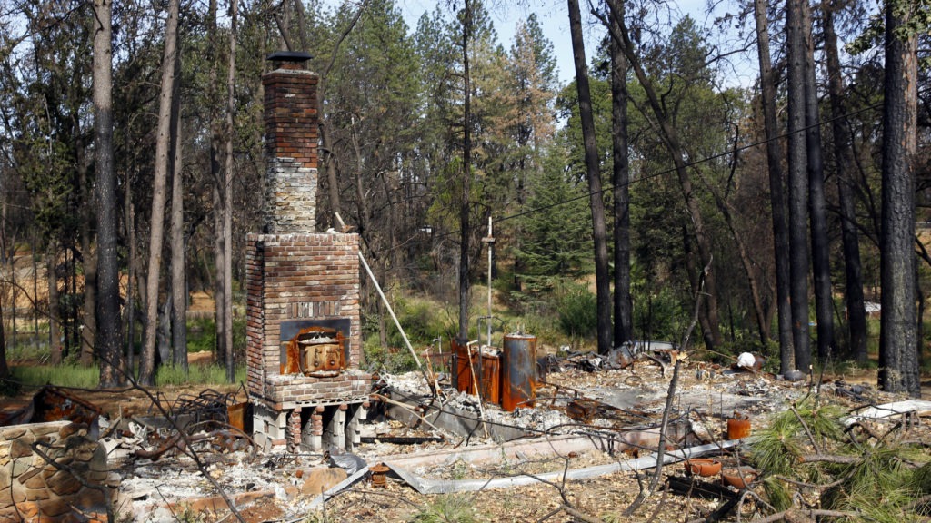 Seen in August 2019, the remains of a home destroyed in Northern California's 2018 Camp Fire. Rich Pedroncelli/AP