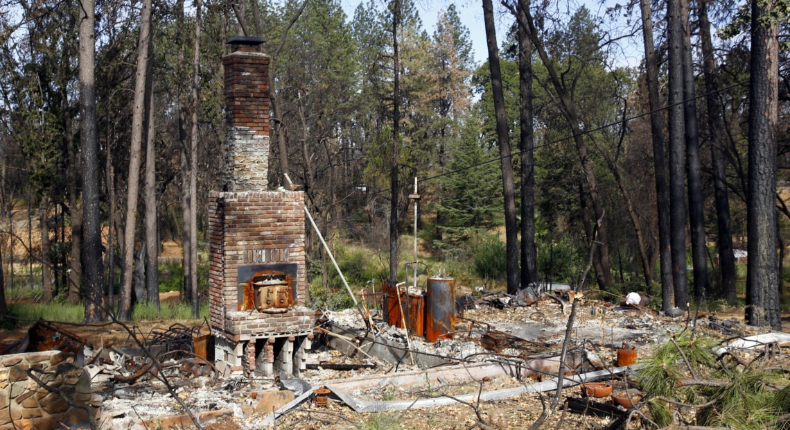 Seen in August 2019, the remains of a home destroyed in Northern California's 2018 Camp Fire. Rich Pedroncelli/AP