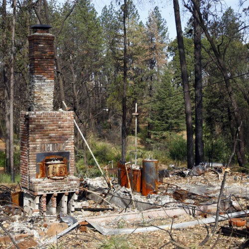 Seen in August 2019, the remains of a home destroyed in Northern California's 2018 Camp Fire. Rich Pedroncelli/AP