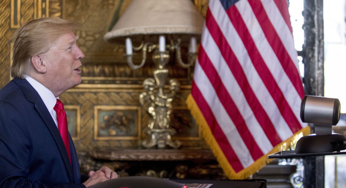 During a Christmas Eve video teleconference, President Trump speaks with members of the military from his Mar-a-Lago estate in Palm Beach, Fla. CREDIT: Andrew Harnik/AP