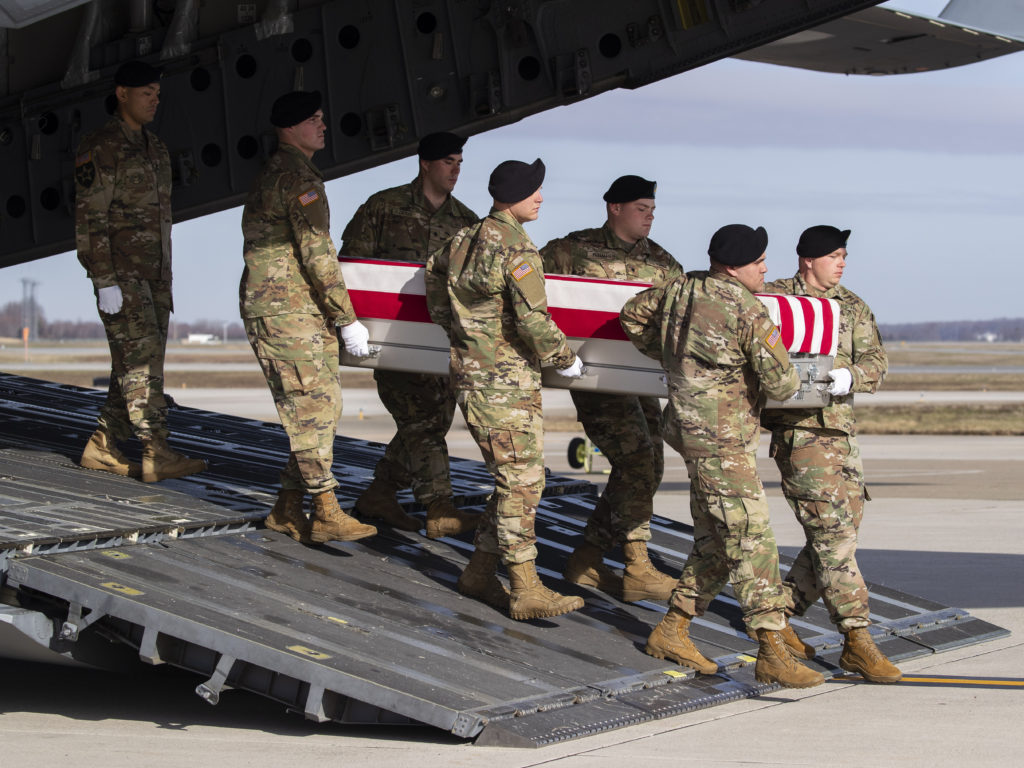 n this Dec. 25, 2019 photo, an Army carry team moves a transfer case containing the remains of U.S. Army Sgt. 1st Class Michael Goble, at Dover Air Force Base in Delaware. The U.S. Special Forces soldier died in Afghanistan while seizing a Taliban weapons cache. CREDIT: Alex Brandon/AP