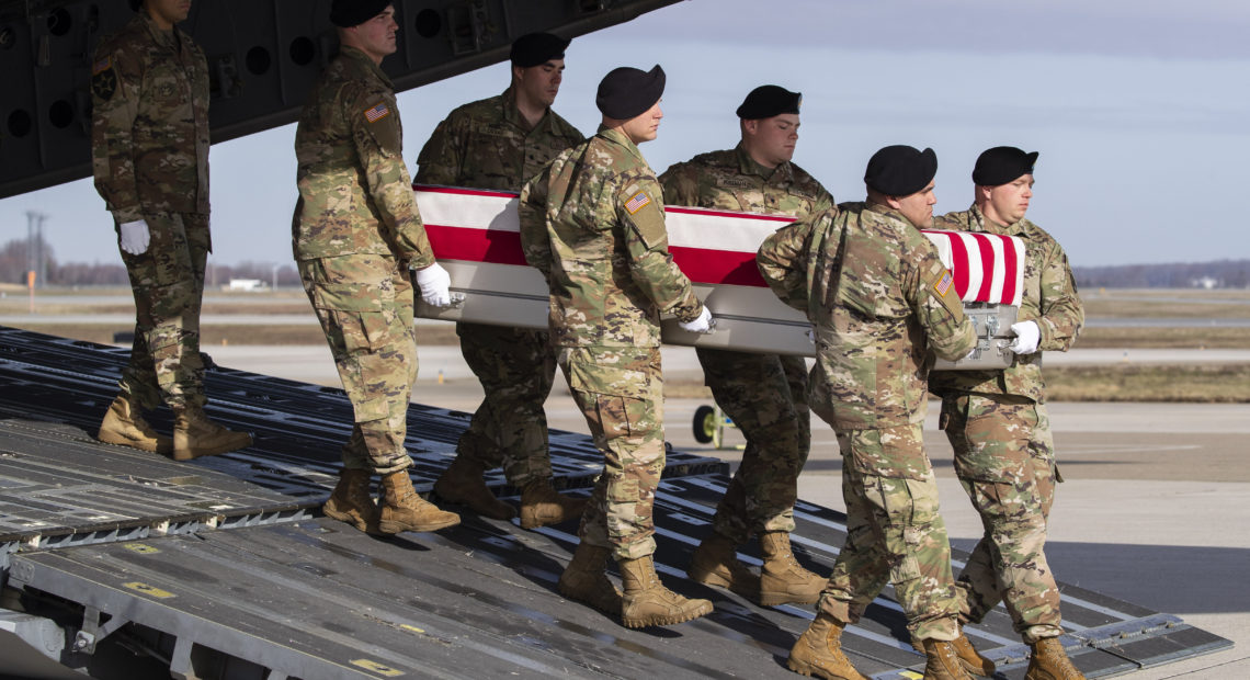 n this Dec. 25, 2019 photo, an Army carry team moves a transfer case containing the remains of U.S. Army Sgt. 1st Class Michael Goble, at Dover Air Force Base in Delaware. The U.S. Special Forces soldier died in Afghanistan while seizing a Taliban weapons cache. CREDIT: Alex Brandon/AP