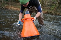 Biologist Jordan Richard pulls a freshwater mussel off the bottom of the Clinch River to see if it's alive. Hundreds of thousands of mussels have perished in the ongoing die-off. CREDIT: Nathan Rott/NPR