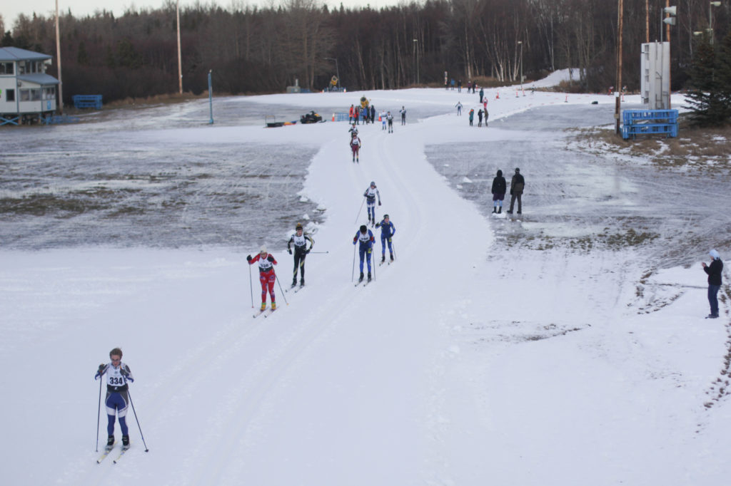 High school skiers compete in the annual Lynx Loppet race at Kincaid Park in Anchorage. The park has 30 miles of trails, but competitors were limited to a mile-long loop of man-made snow. CREDIT: Nat Herz/Alaska's Energy Desk