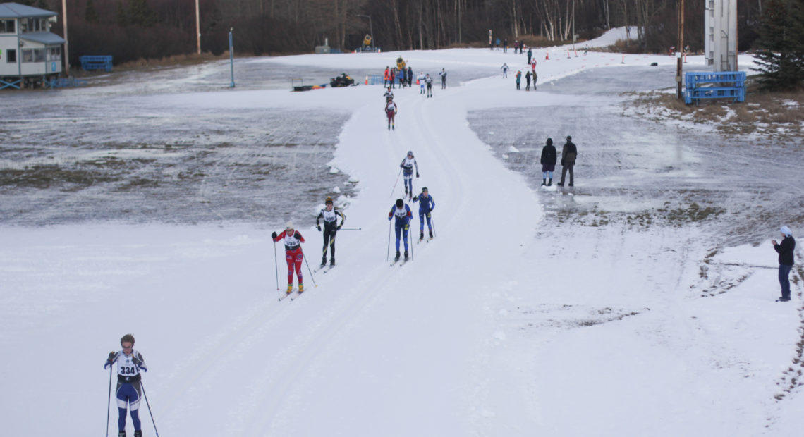 High school skiers compete in the annual Lynx Loppet race at Kincaid Park in Anchorage. The park has 30 miles of trails, but competitors were limited to a mile-long loop of man-made snow. CREDIT: Nat Herz/Alaska's Energy Desk