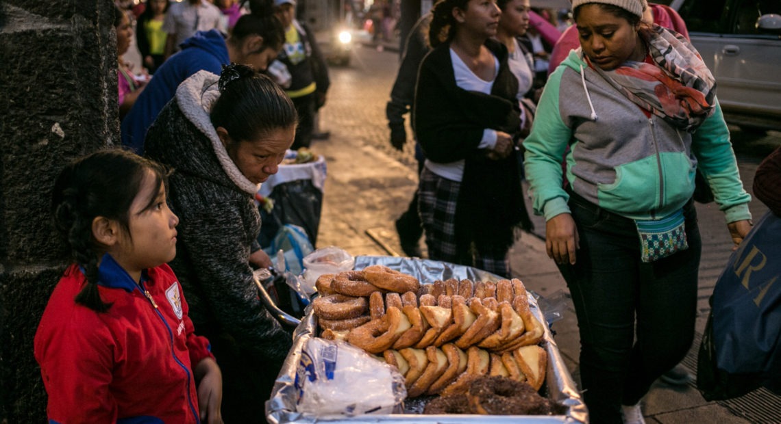 A family sells pastries in Mexico City. As Mexicans' wages have risen, their average daily intake of calories has soared.
