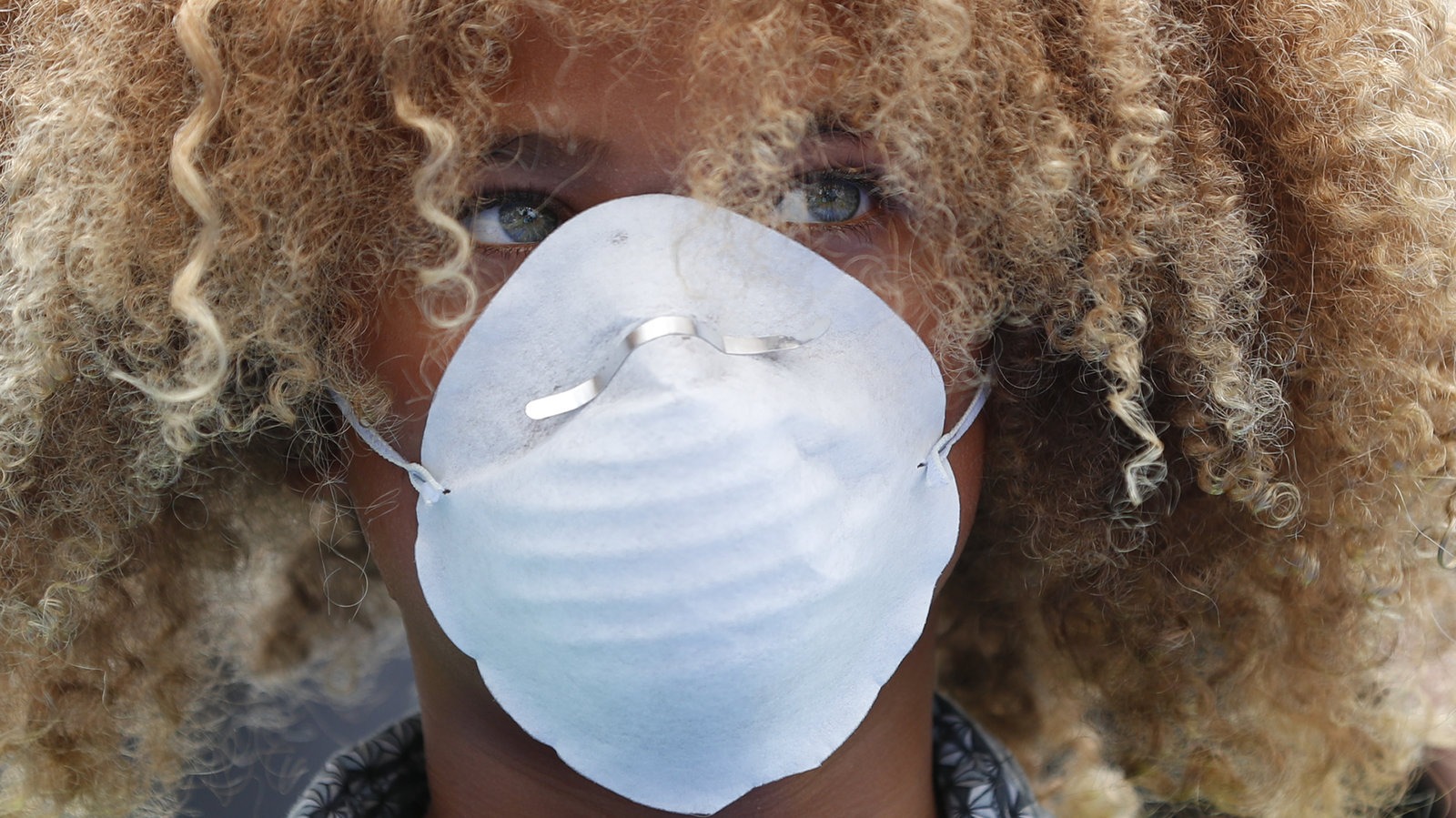 Levi Draheim, 11, wears a dust mask as he participates in a demonstration in Miami in July 2019. A lawsuit filed by him and other young people urging action against climate change was thrown out by a federal appeals court Friday, Jan. 17, 2020. Wilfredo Lee/AP