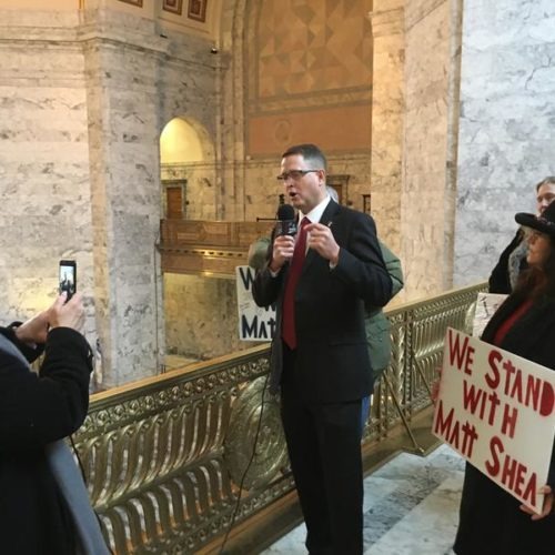 Washington state GOP Rep. Matt Shea records a video on the first day of the legislative session while a small group of supporters gather around him. CREDIT: Austin Jenkins/N3