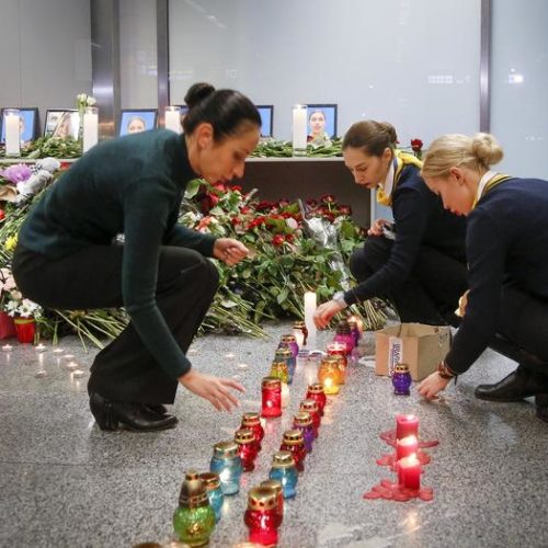 Colleagues of the flight crew members of the Ukrainian 737-800 plane that crashed on the outskirts of Tehran, light candles at a memorial inside Borispil International Airport near Kyiv. CREDIT: Efrem Lukatsky/AP