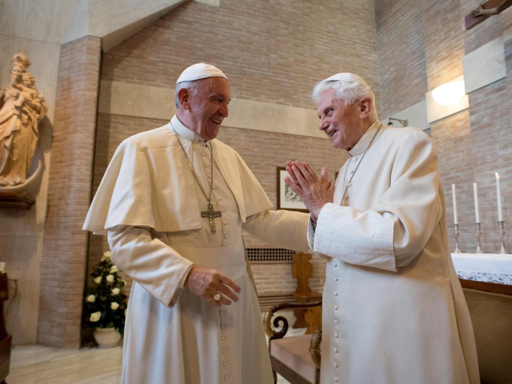 Pope Francis (left) talks with Pope Emeritus Benedict XVI in the former Convent Mater Ecclesiae at the Vatican in 2016, three years after Benedict stunned the Catholic Church by resigning to become pope emeritus. CREDIT: L'Osservatore Romano/AP