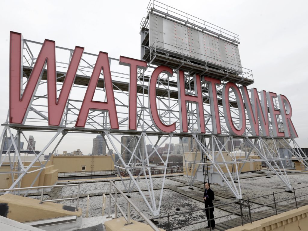 Two women who were sexually abused as children say the Jehovah's Witnesses failed to report their abuser to authorities in Montana and instead expelled him from the congregation as punishment until he repented. Pictured, in 2015, is a sign atop the then-world headquarters of the Jehovah's Witnesses in New York. CREDIT: Seth Wenig/AP