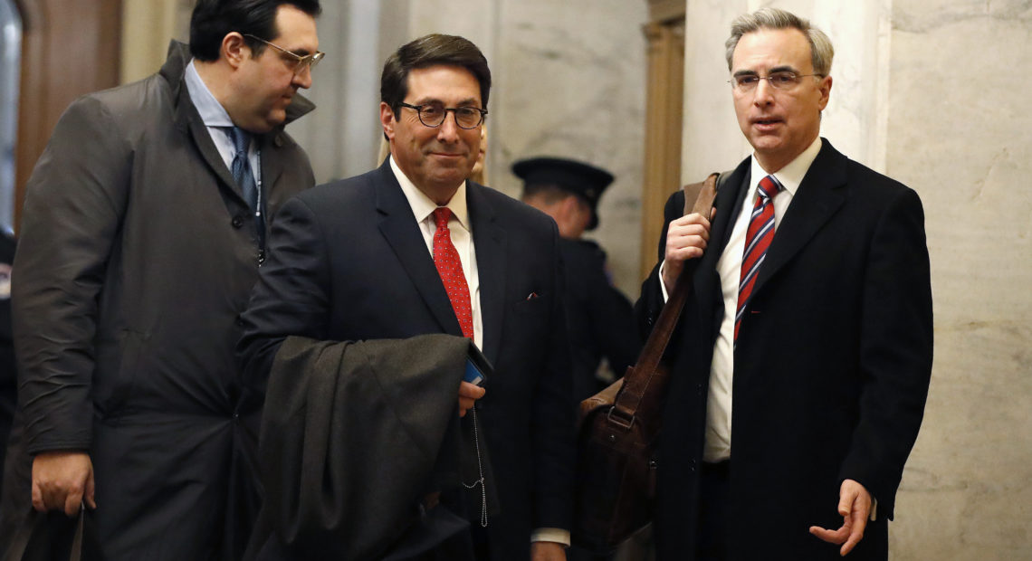 President Trump's personal attorney Jay Sekulow (center) stands with his son, Jordan Sekulow (left), and White House counsel Pat Cipollone in the Capitol on Saturday. CREDIT: Julio Cortez/AP