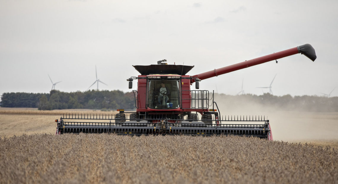 A farmer operates a combine to harvest soybeans in Wyanet, Ill. Farmers got more than $22 billion in government payments in 2019. It's the highest level of farm subsidies in 14 years. CREDIT: Bloomberg via Getty Images