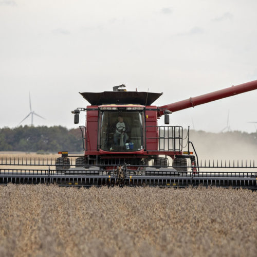 A farmer operates a combine to harvest soybeans in Wyanet, Ill. Farmers got more than $22 billion in government payments in 2019. It's the highest level of farm subsidies in 14 years. CREDIT: Bloomberg via Getty Images