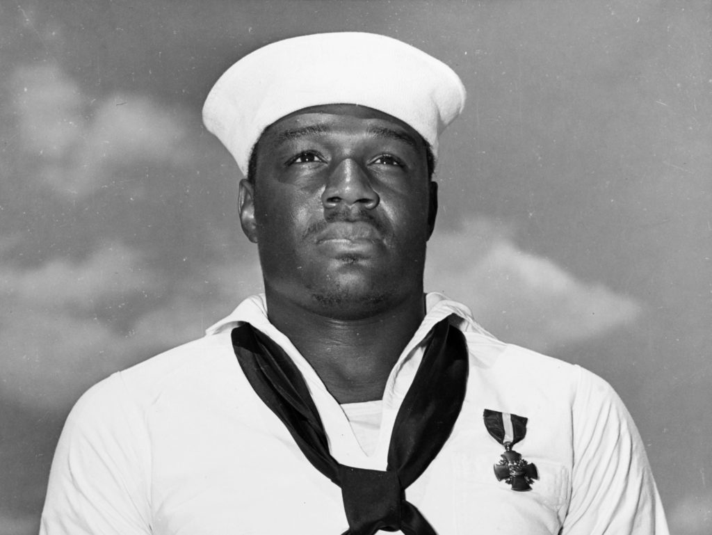 In this photo taken May 27, 1942, Mess Attendant 2nd Class Doris Miller stands at attention after being awarded the Navy Cross for for his actions aboard the USS West Virginia during the Japanese attack on Pearl Harbor on Dec. 7, 1941. CREDIT: U.S. Navy