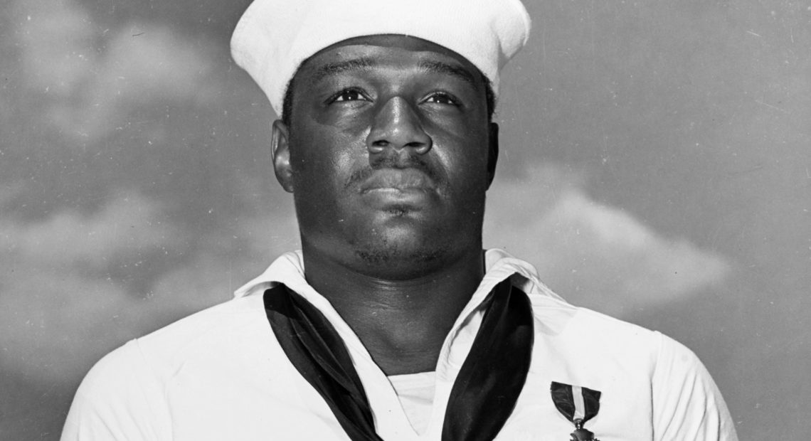 In this photo taken May 27, 1942, Mess Attendant 2nd Class Doris Miller stands at attention after being awarded the Navy Cross for for his actions aboard the USS West Virginia during the Japanese attack on Pearl Harbor on Dec. 7, 1941. CREDIT: U.S. Navy