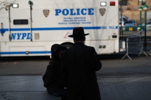 People walk through the Orthodox Jewish section of a Brooklyn neighborhood last month. Tensions remain high in Jewish communities following a series of attacks and incidents in recent weeks. CREDITS: Spencer Platt/Getty Images