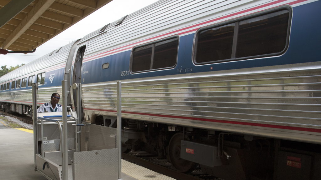 A member of the station staff pushes a portable wheelchair lift along the platform at an Amtrak station in DeLand, Fla. The company says its policies for having to adjust or remove seats has changed. Education Images/Universal Images Group via Getty Images