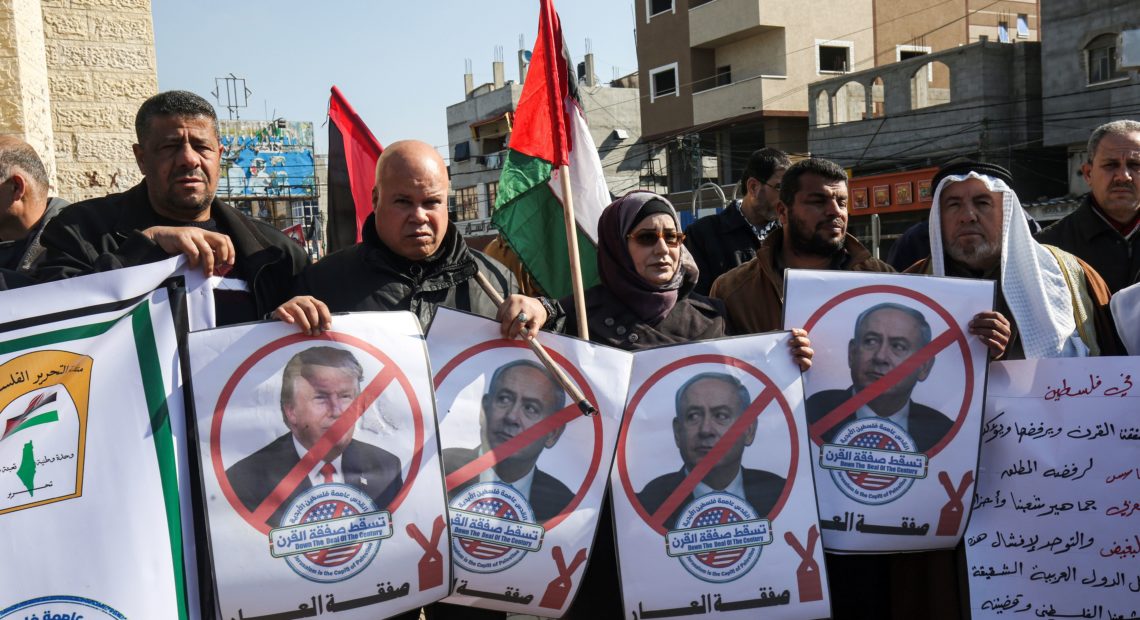 Palestinian demonstrators in Rafah, in the southern Gaza strip, hold portraits of President Trump and Israeli Prime Minister Benjamin Netanyahu during a protest against Trump's announcement of a peace plan on Tuesday, Jan. 28, 2020. Said Khatib/AFP via Getty Images