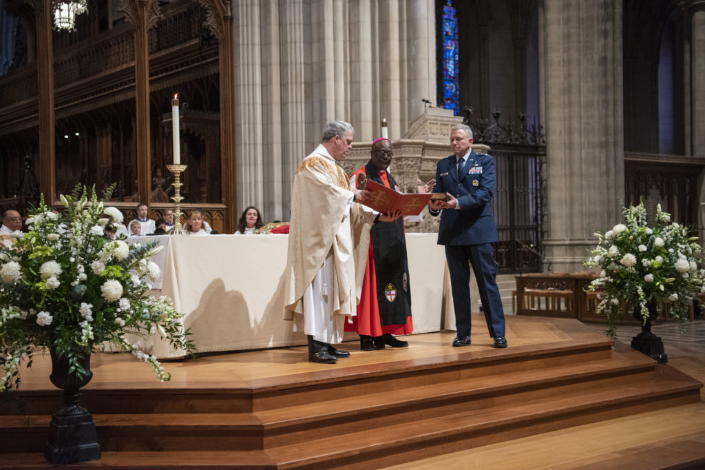 The Rev. Randolph Hollerith, dean of the Washington National Cathedral (from left); the Rev. Carl Wright, the Episcopal Church's bishop suffragan for the armed forces; and Maj. Gen. Steven Schaick, the Air Force chief of chaplains, participate in the blessing of a Bible for swearing in U.S. Space Force officials. Danielle E. CREDIT: Thomas/Washington National Cathedral