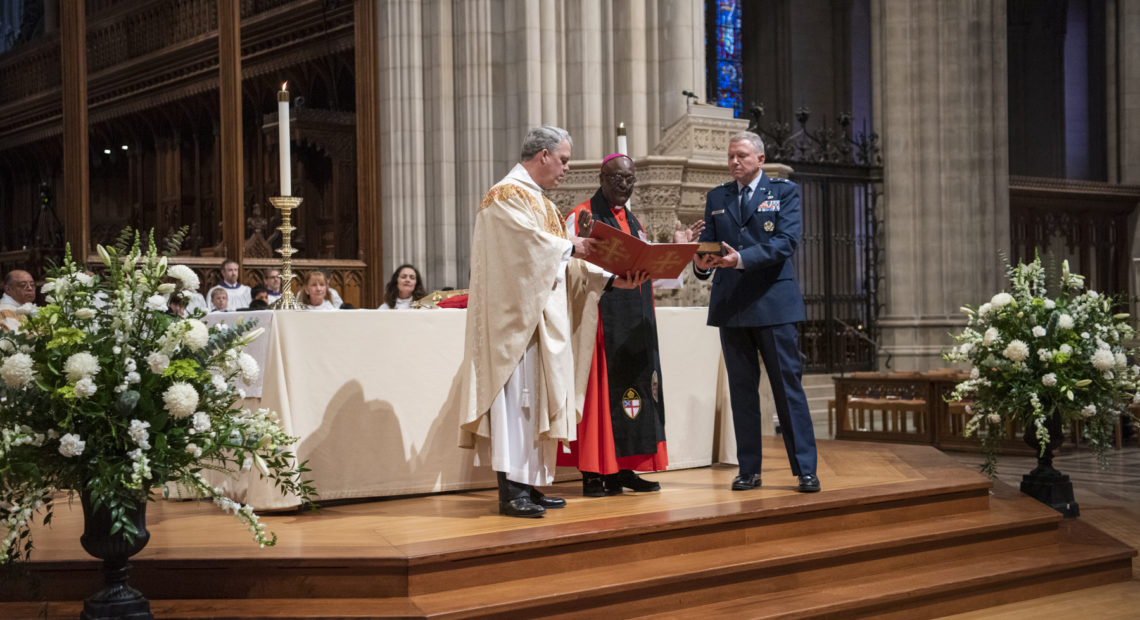 The Rev. Randolph Hollerith, dean of the Washington National Cathedral (from left); the Rev. Carl Wright, the Episcopal Church's bishop suffragan for the armed forces; and Maj. Gen. Steven Schaick, the Air Force chief of chaplains, participate in the blessing of a Bible for swearing in U.S. Space Force officials. Danielle E. CREDIT: Thomas/Washington National Cathedral