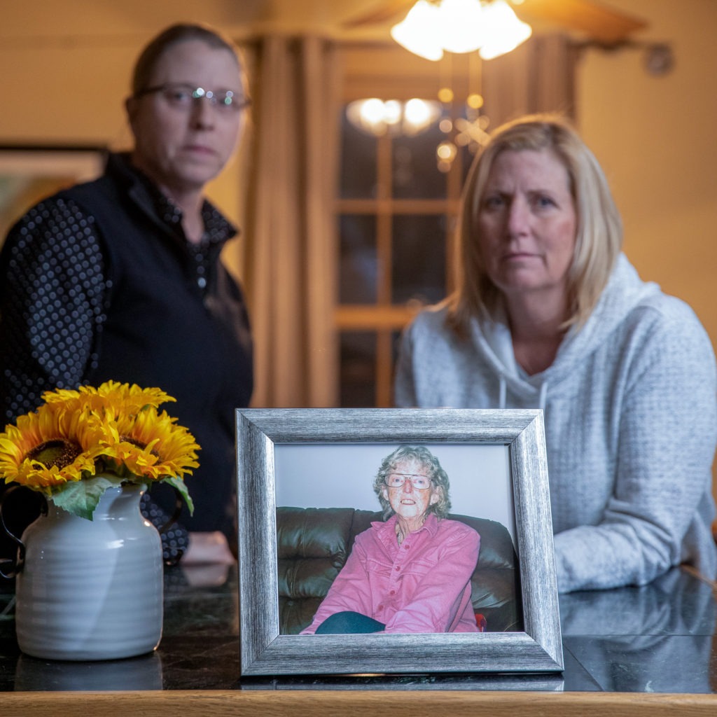 June (left) and Mary Kelly with a photo of their mother, Marilyn Kelly. Marilyn was living at Our House Too, in Rutland, Vt., before she died. James Buck/VPR/Seven Days