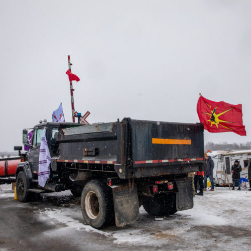 A truck sits parked at railway tracks during a protest near Belleville, Ontario, Canada, on Thursday. Demonstrators have been disrupting railroads and other infrastructure across Canada for more than a week to protest the planned Coastal GasLink pipeline. CREDIT: Bloomberg via Getty Images
