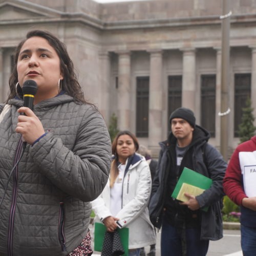 Former Yakima City councilmember Dulce Gutiérrez spoke to other immigrant rights advocates gathered on the steps to the state capitol as undocumented residents Wendy, Saul and Jorge listened from behind.