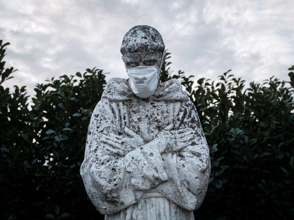 A face mask adorns a statue of St. Francis of Assisi in the town of San Fiorano, one of the places in Italy on lockdown due to the novel coronavirus outbreak. The picture was taken by schoolteacher Marzio Toniolo. Marzio Toniolo/via Reuters