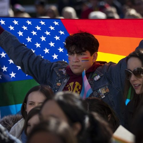 Nicolas Velasquez, 17, holds a rainbow flag during a walkout to protest the departure of two LGBT educators on Tuesday, February 18, 2020, at Kennedy Catholic High School in Burien. "I don't think that it's okay that this is happening now," Velasquez said. "I want to be the change that I want to see."