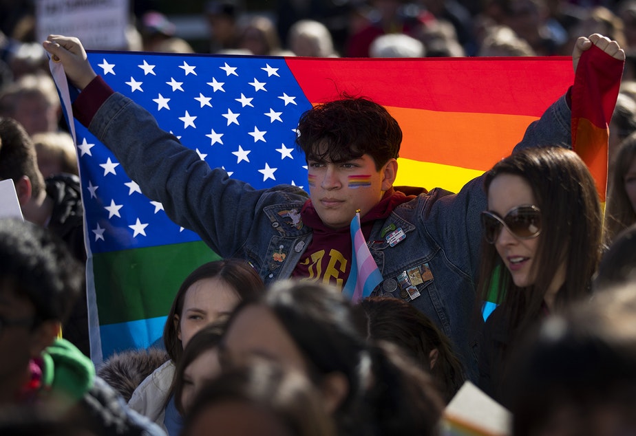 Nicolas Velasquez, 17, holds a rainbow flag during a walkout to protest the departure of two LGBT educators on Tuesday, February 18, 2020, at Kennedy Catholic High School in Burien. "I don't think that it's okay that this is happening now," Velasquez said. "I want to be the change that I want to see."